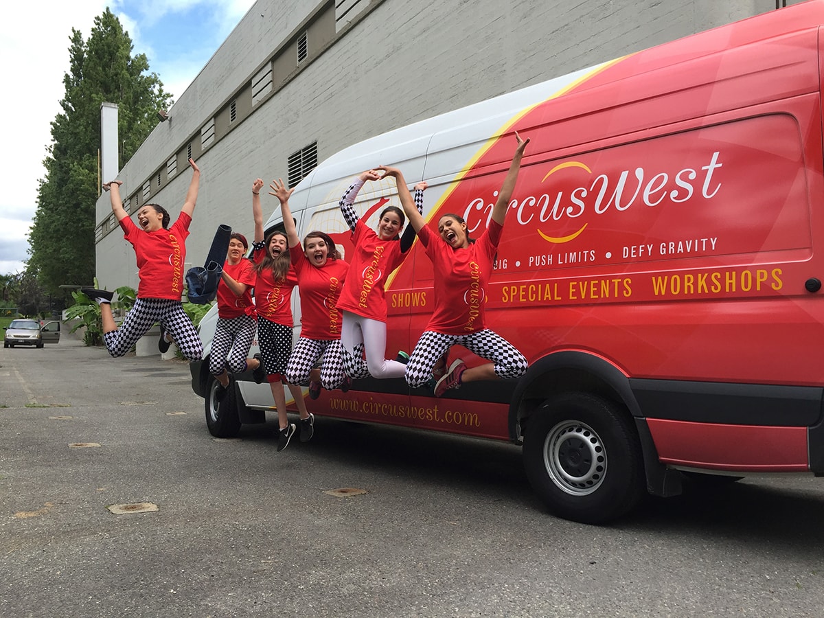 COMMUNITY INVOLVMENTJPG-min Jumping Kids in front of van